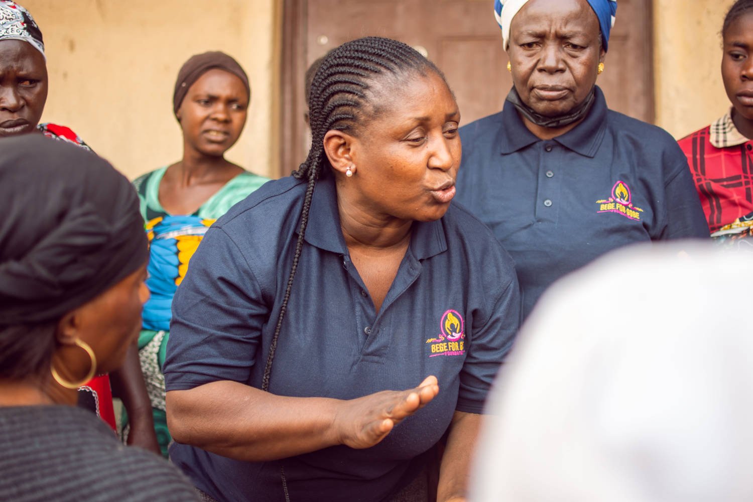 Missionary woman giving instructions to others.