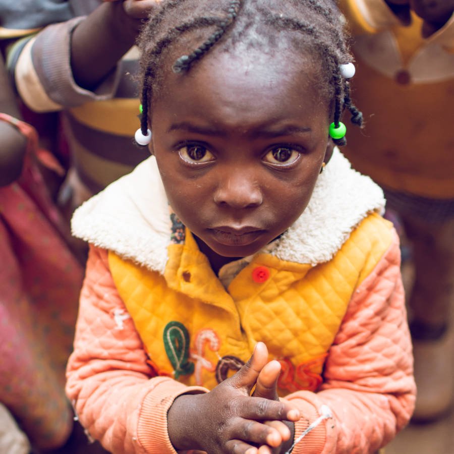 Child at IDP camp waiting for food.